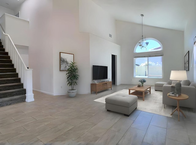 living area with a high ceiling and stairs