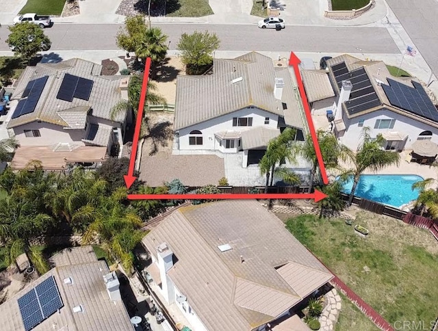 aerial perspective of suburban area featuring property parcel outlined and a pool area