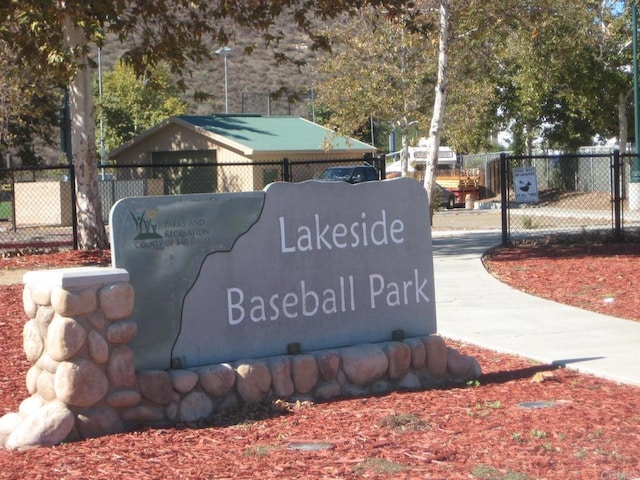 community / neighborhood sign with fence