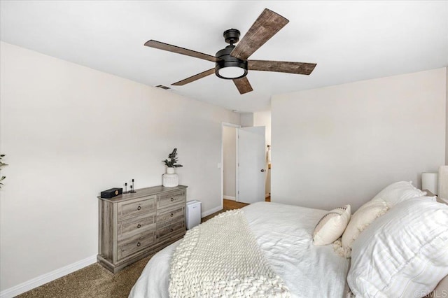 bedroom featuring dark carpet, baseboards, and ceiling fan