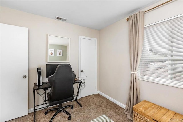carpeted office space featuring baseboards