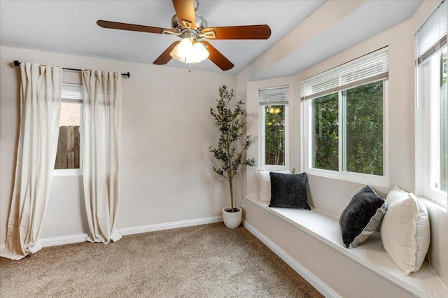 sitting room with light colored carpet, baseboards, and ceiling fan