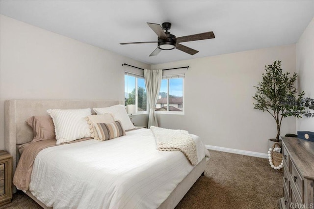 bedroom featuring dark carpet, baseboards, and a ceiling fan