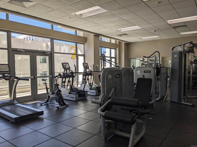 exercise room featuring french doors and a drop ceiling