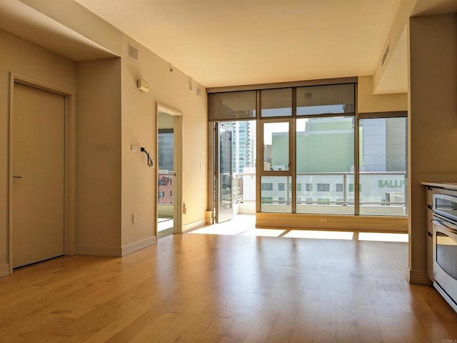 unfurnished living room featuring light wood-style floors and baseboards