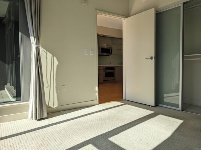 unfurnished bedroom with a closet and carpet floors
