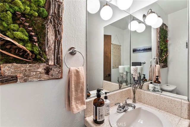 bathroom featuring a sink and toilet