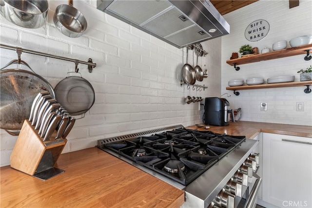 kitchen featuring open shelves, extractor fan, butcher block counters, wood finished floors, and white cabinets