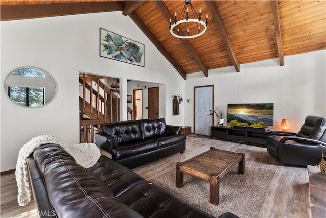 living area with wood finished floors, wood ceiling, a chandelier, high vaulted ceiling, and stairs
