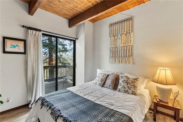 bedroom featuring access to outside, beamed ceiling, wood finished floors, wooden ceiling, and baseboards