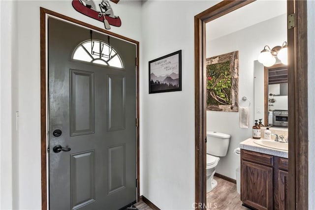 entryway with light wood-style floors and baseboards