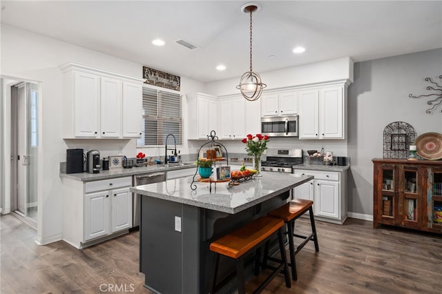 11905 Mendenhall Ln, Whittier, CA 90601 - kitchen with appliances with stainless steel finishes, a sink, white cabinets, a center island, and recessed lighting