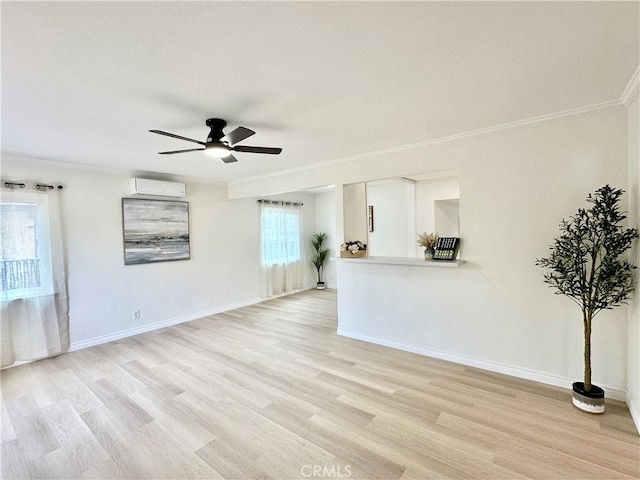 unfurnished living room featuring a wall mounted air conditioner, ornamental molding, a ceiling fan, light wood-style floors, and baseboards