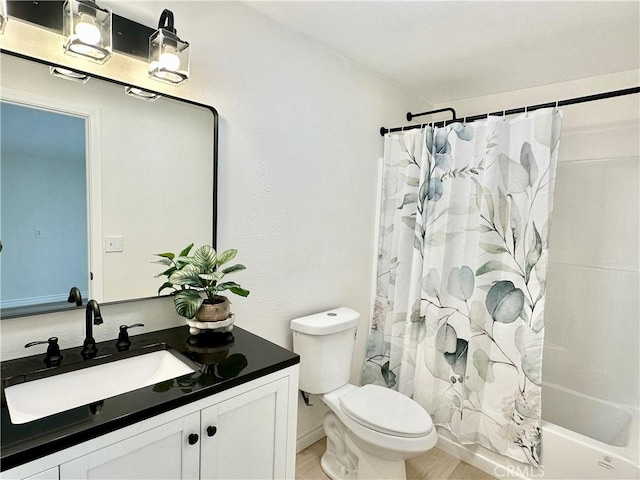 full bathroom with toilet, vanity, and shower / tub combo