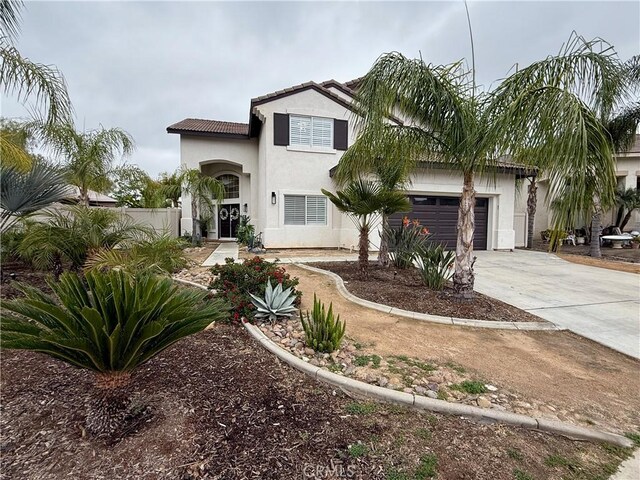 23 Ponte Sonata, Lake Elsinore, CA 92532 - view of front of home featuring driveway, stucco siding, an attached garage, and fence