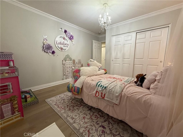23 Ponte Sonata, Lake Elsinore, CA 92532 - bedroom with a closet, a chandelier, ornamental molding, wood finished floors, and baseboards