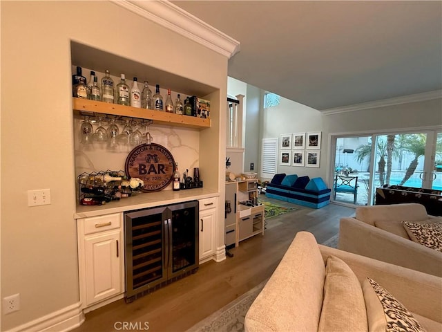 23 Ponte Sonata, Lake Elsinore, CA 92532 - indoor dry bar with beverage cooler, crown molding, and dark wood finished floors