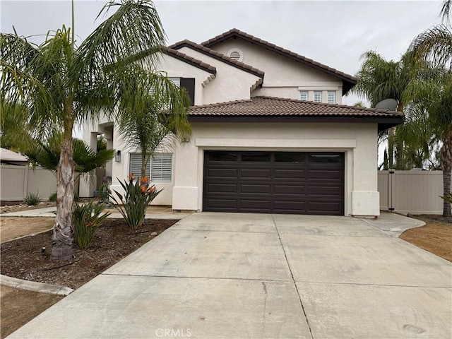 23 Ponte Sonata, Lake Elsinore, CA 92532 - mediterranean / spanish-style house featuring a garage, stucco siding, concrete driveway, and fence