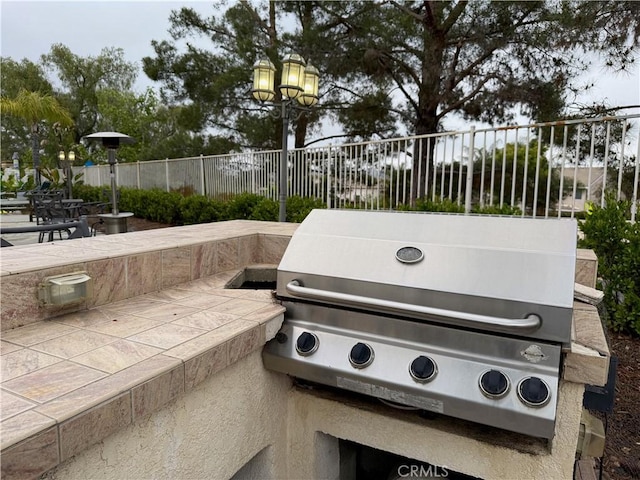 23 Ponte Sonata, Lake Elsinore, CA 92532 - view of patio with a grill and fence