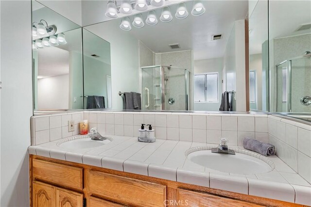 4864 Hersholt Ave, Long Beach, CA 90808 - full bathroom featuring a shower stall, double vanity, and backsplash