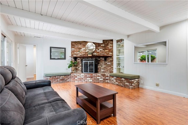 4864 Hersholt Ave, Long Beach, CA 90808 - living room with wood finished floors, beamed ceiling, a fireplace, baseboards, and wooden ceiling
