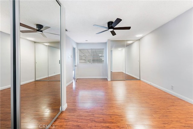 4864 Hersholt Ave, Long Beach, CA 90808 - unfurnished bedroom with wood finished floors, baseboards, a ceiling fan, and a textured ceiling