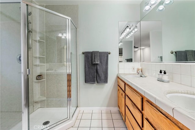 4864 Hersholt Ave, Long Beach, CA 90808 - full bathroom with tile patterned flooring, a shower stall, double vanity, and tasteful backsplash