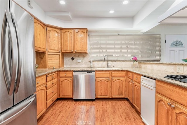 4864 Hersholt Ave, Long Beach, CA 90808 - kitchen with stainless steel appliances, a sink, light wood-type flooring, backsplash, and light stone counters