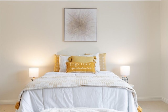carpeted bedroom featuring baseboards