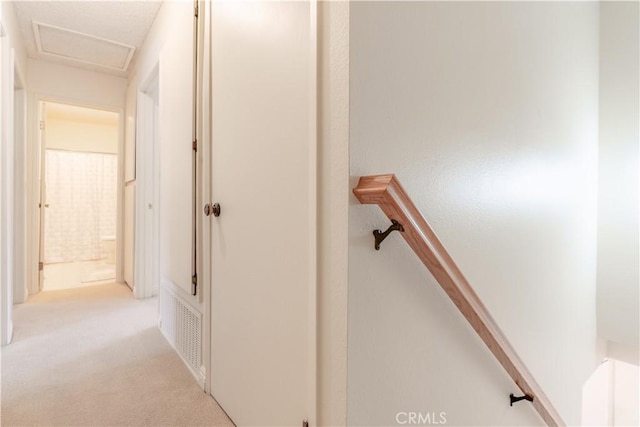 hall featuring carpet flooring
