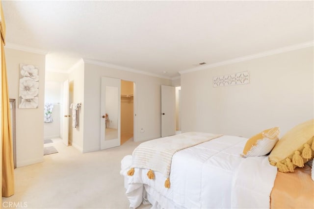 carpeted bedroom featuring ornamental molding, a walk in closet, and a closet