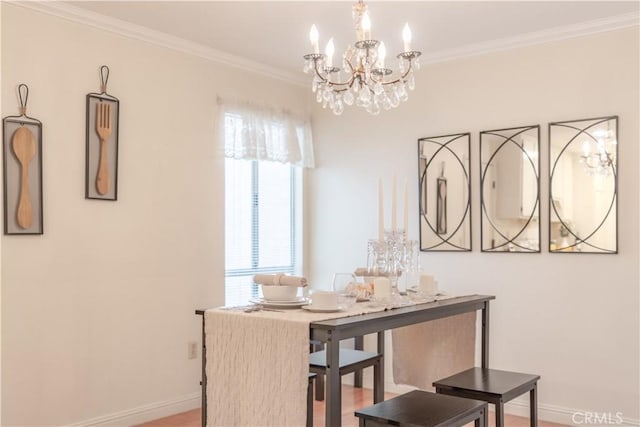 dining area featuring a chandelier, baseboards, ornamental molding, and wood finished floors