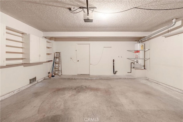 garage with water heater and a garage door opener
