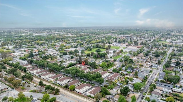 aerial view of property and surrounding area featuring nearby suburban area