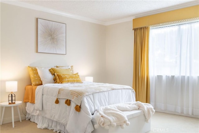 carpeted bedroom featuring ornamental molding and a textured ceiling