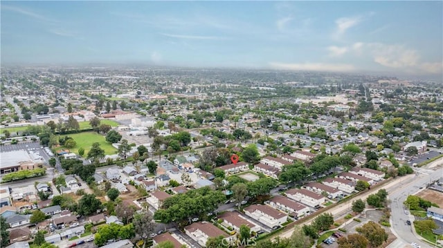 aerial view of property and surrounding area with nearby suburban area