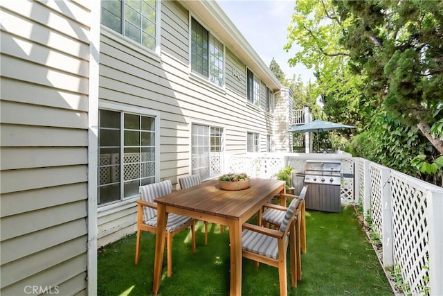 balcony featuring area for grilling and outdoor dining space