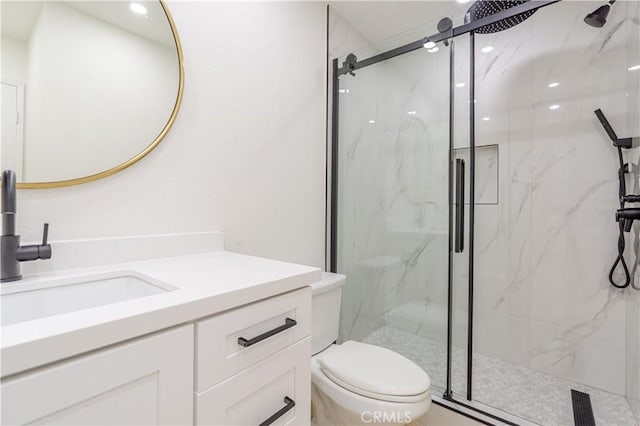 bathroom with toilet, a marble finish shower, and vanity