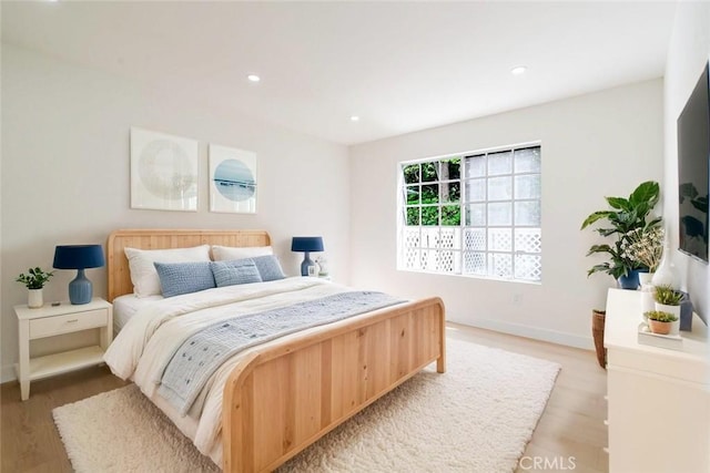 bedroom with light wood finished floors, recessed lighting, and baseboards