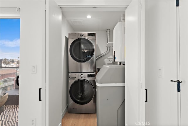 321 S Oxford Ave Unit 603, Los Angeles, CA 90020 - laundry area featuring stacked washer / dryer and wood finished floors