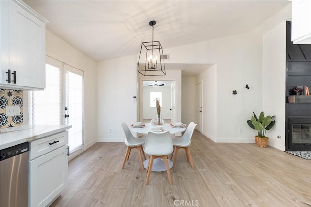 dining room featuring light wood-style floors, healthy amount of natural light, and baseboards