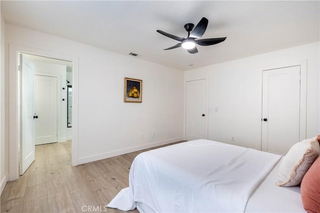 bedroom featuring light wood-type flooring, baseboards, and ceiling fan