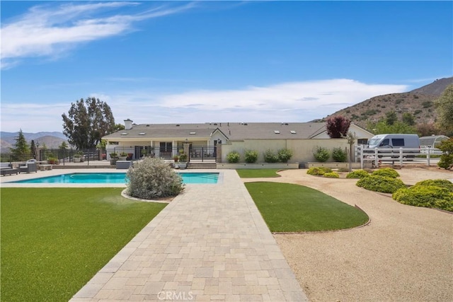 view of pool featuring a mountain view and a patio area