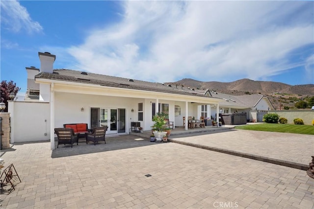 back of house featuring an outdoor hangout area, a patio, fence, and a mountain view