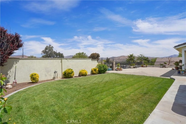view of yard with a patio and a mountain view