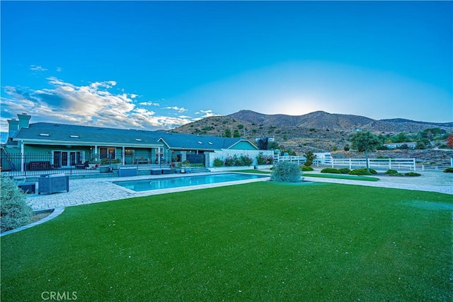 view of swimming pool with a mountain view and a patio area