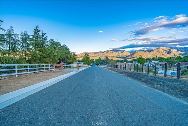 view of asphalt road featuring a mountain view