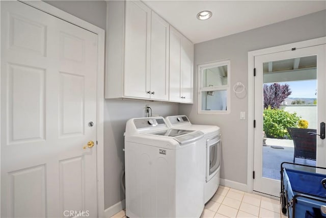 clothes washing area featuring washing machine and dryer, cabinet space, baseboards, light tile patterned flooring, and recessed lighting