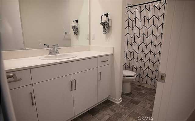 bathroom with toilet, vanity, and a shower with curtain