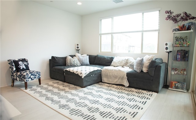 living room with light wood-style floors and recessed lighting